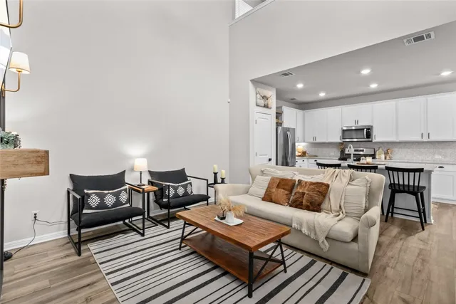 a living room with furniture and kitchen view