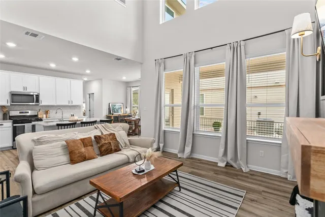 a living room with furniture wooden floor and a table