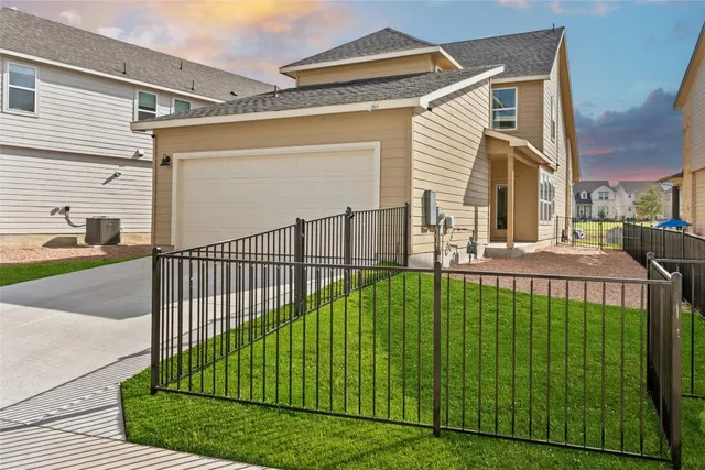a view of a house with backyard and sitting area