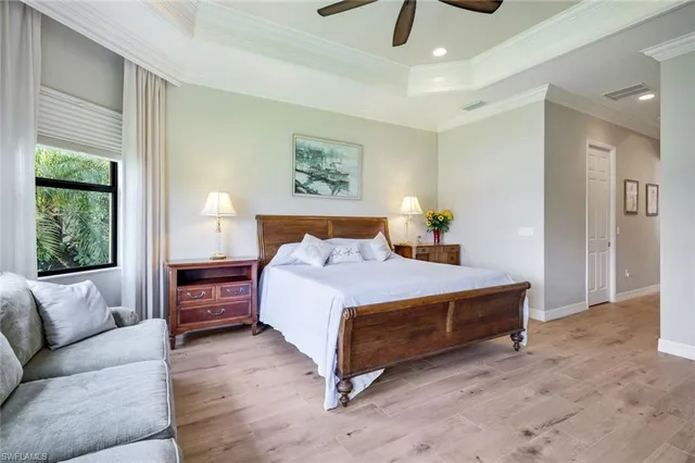 a spacious bedroom with a bed a couch and a window