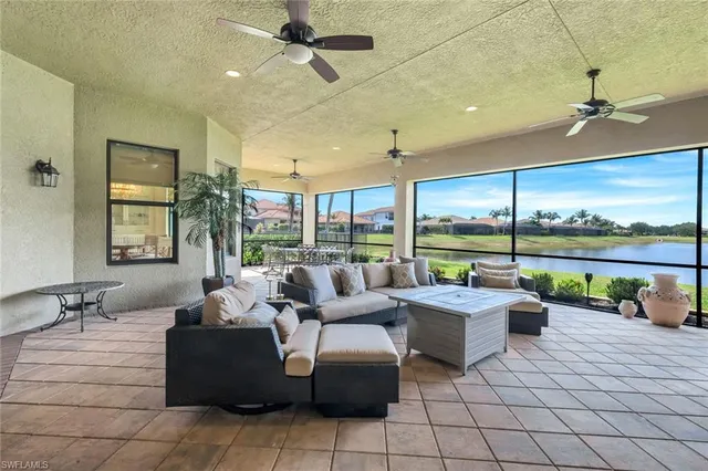 a living room with patio furniture and a floor to ceiling window
