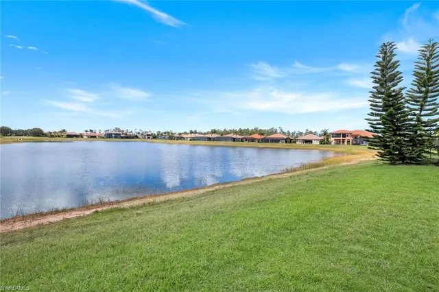 a view of a lake with houses in the back