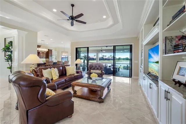 a living room with furniture flat screen tv and a large window