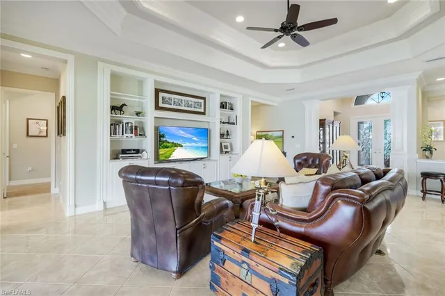 a living room with furniture a ceiling fan and a window