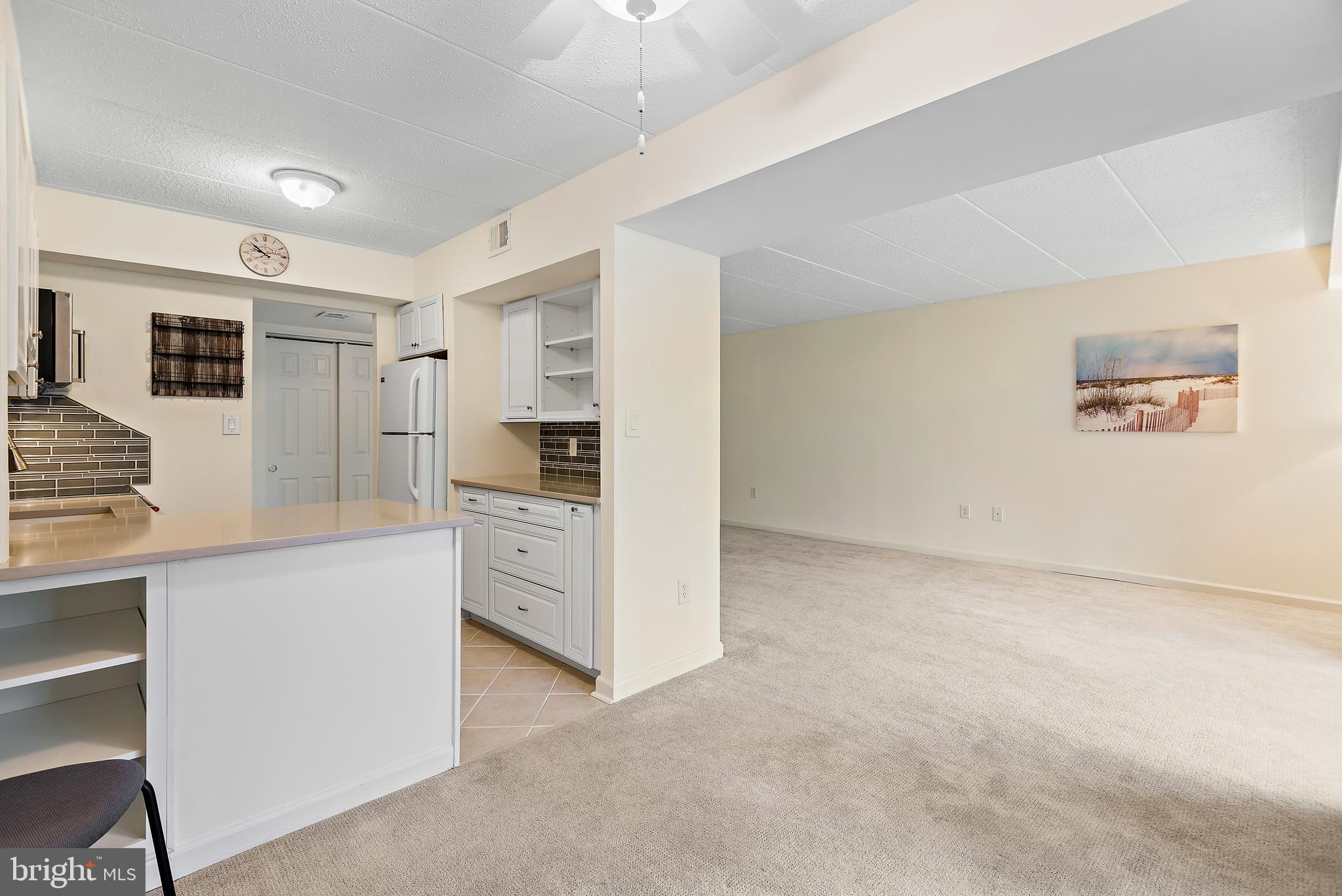 5707 Harpers Farm Road, Unit A Columbia, MD 21044 - Photo 11 of 30 a kitchen with white cabinets and stainless steel appliances