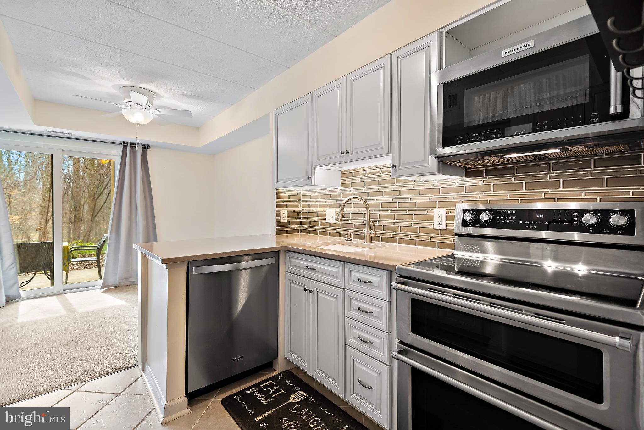 5707 Harpers Farm Road, Unit A Columbia, MD 21044 - Photo 2 of 30 a kitchen with granite countertop a stove and a microwave