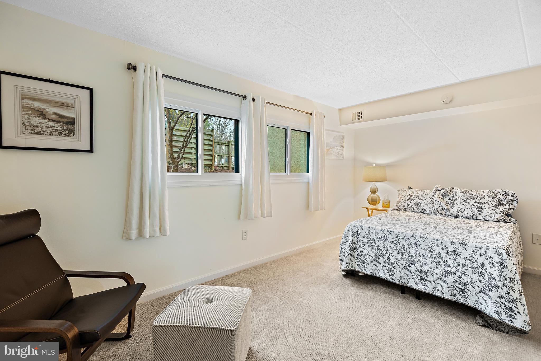 5707 Harpers Farm Road, Unit A Columbia, MD 21044 - Photo 22 of 30 a bedroom with a bed and a window