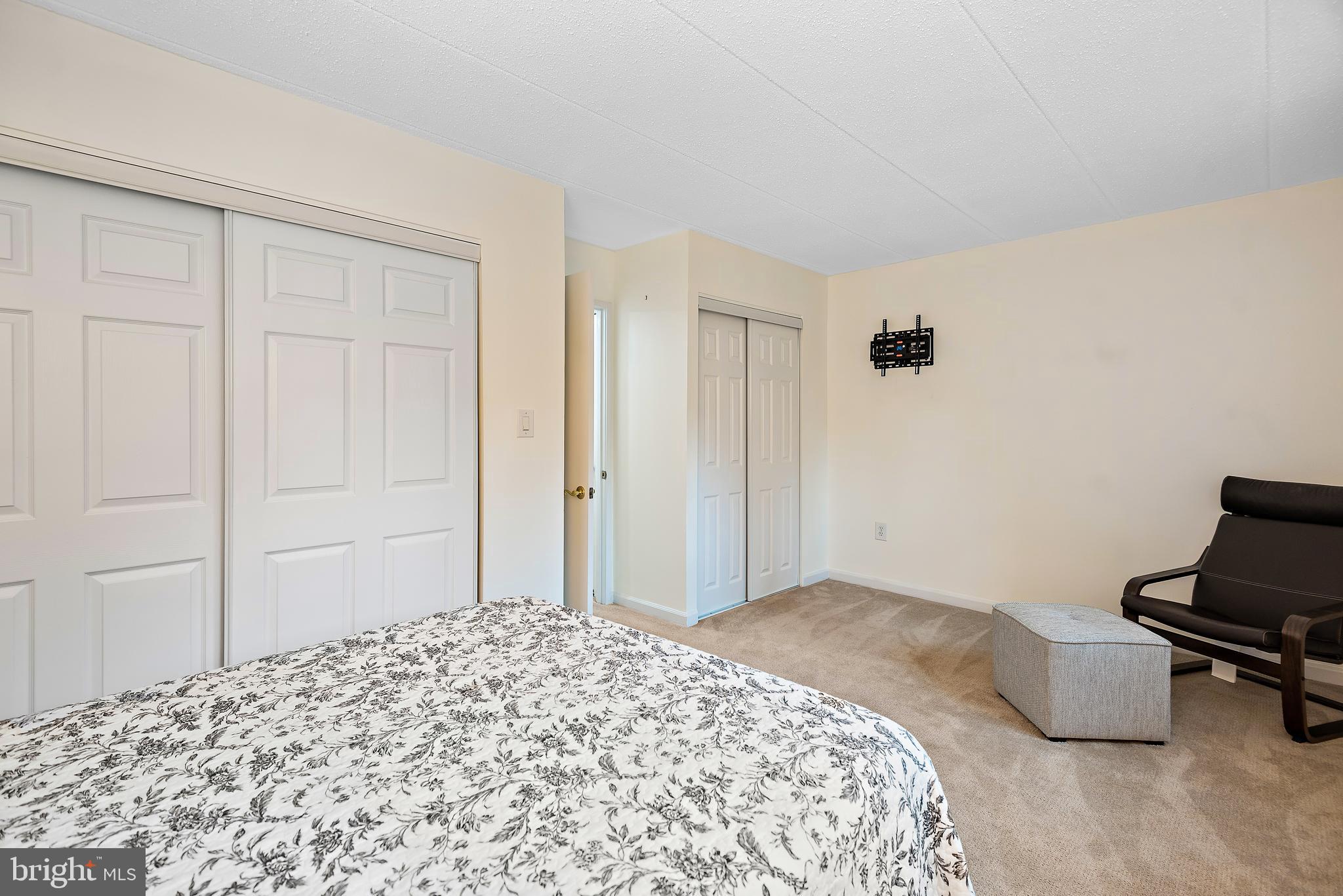 5707 Harpers Farm Road, Unit A Columbia, MD 21044 - Photo 23 of 30 a bedroom with a bed and a dresser in it