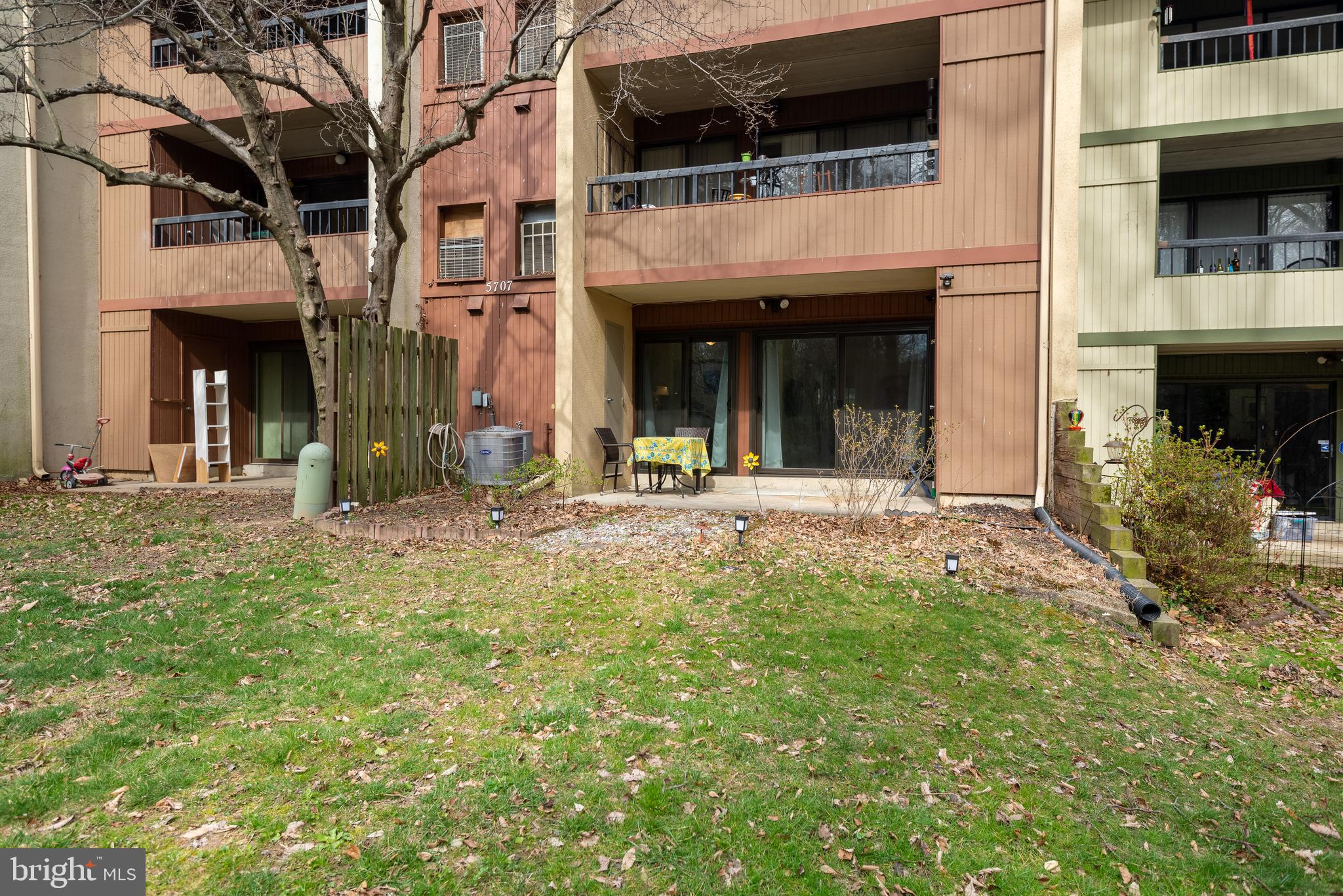 5707 Harpers Farm Road, Unit A Columbia, MD 21044 - Photo 26 of 30 a view of a white house with a small yard and plants