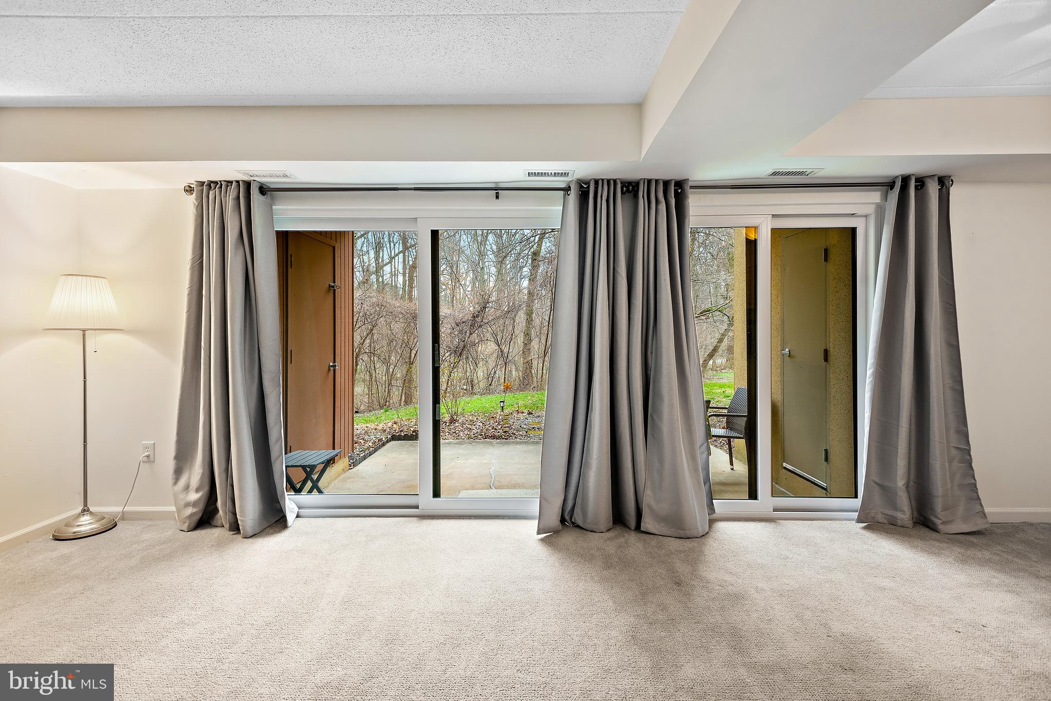 5707 Harpers Farm Road, Unit A Columbia, MD 21044 - Photo 3 of 30 an empty room with floor to ceiling windows and floor to ceiling window
