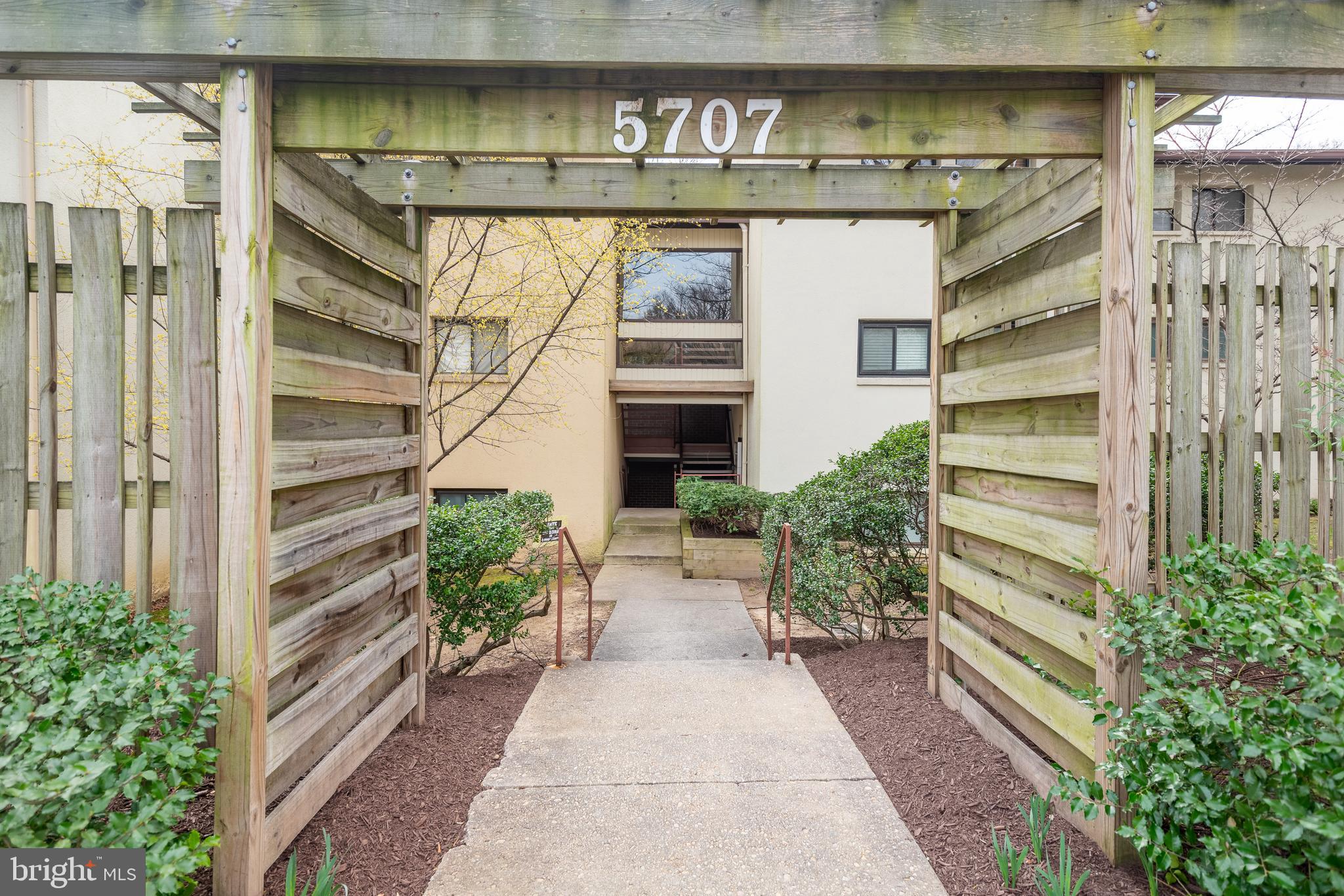 5707 Harpers Farm Road, Unit A Columbia, MD 21044 - Photo 6 of 30 a front view of a house with a yard and potted plants