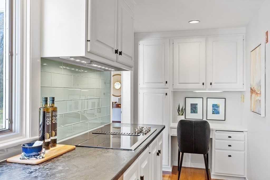3 Goodwin Road Lexington, MA 02420 - Photo 11 of 38 a view of a kitchen with workspace and mirror