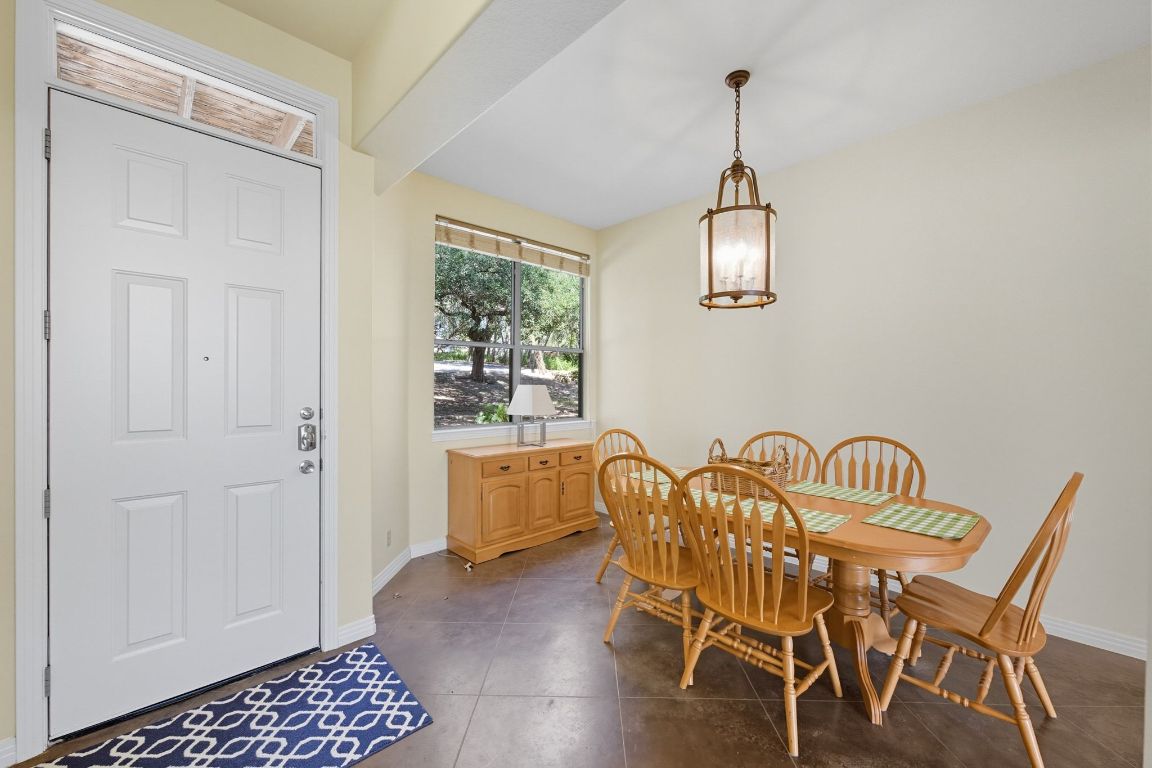 1101 Oak Hurst Road, Unit 100 Austin, TX 78734 - Photo 14 of 35 a view of a dining room with furniture and wooden floor