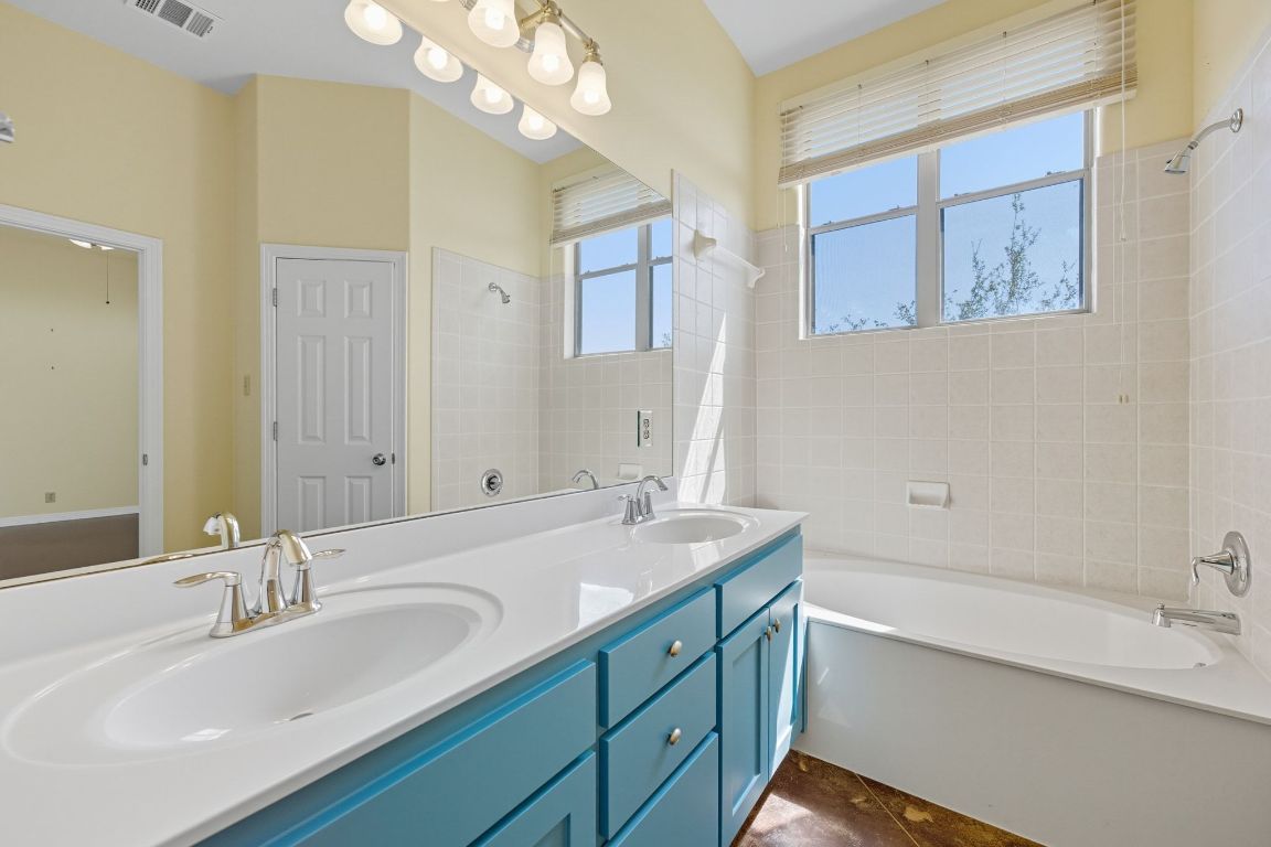 1101 Oak Hurst Road, Unit 100 Austin, TX 78734 - Photo 18 of 35 a bathroom with a granite countertop sink mirror and double