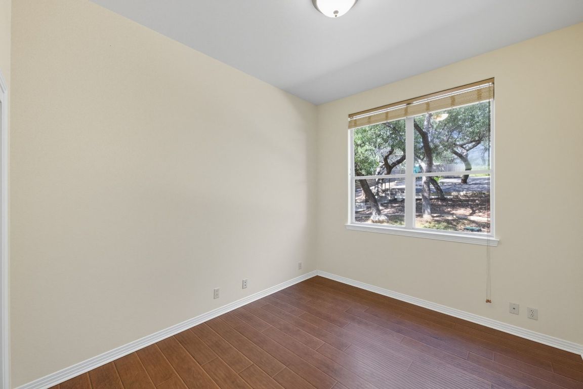 1101 Oak Hurst Road, Unit 100 Austin, TX 78734 - Photo 20 of 35 an empty room with wooden floor and windows