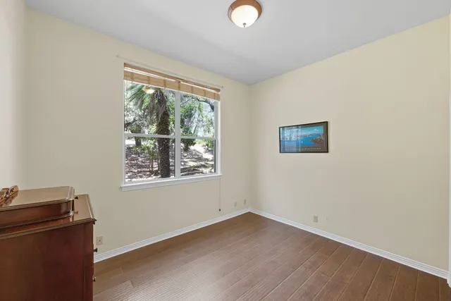 a view of a livingroom with wooden floor and a window
