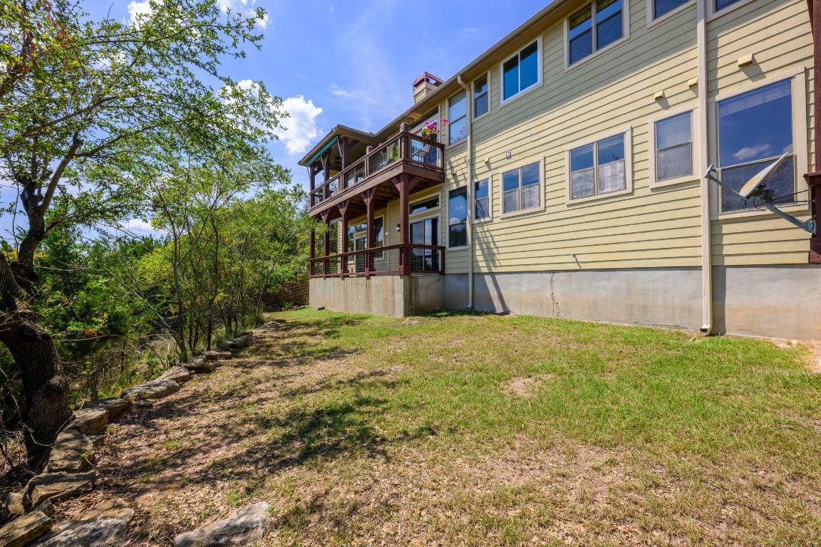 1101 Oak Hurst Road, Unit 100 Austin, TX 78734 - Photo 32 of 35 a view of a house with a yard and sitting area