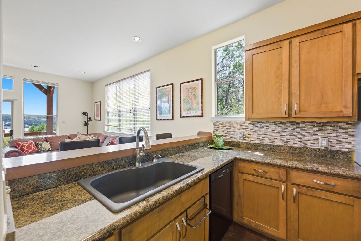 1101 Oak Hurst Road, Unit 100 Austin, TX 78734 - Photo 9 of 35 a kitchen with a sink and a white cabinets