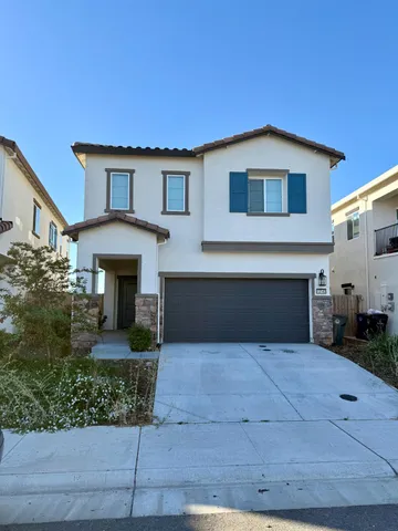 a front view of house with yard garage and green space