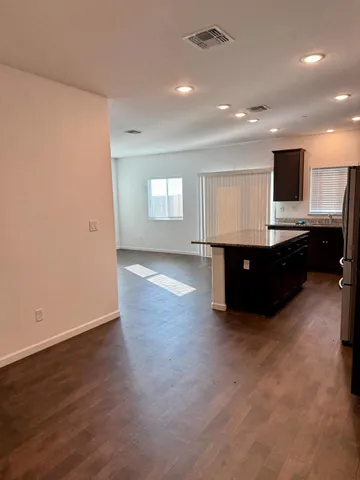 an empty room with wooden floor and furniture