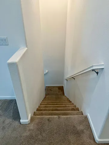 an empty room with closet and mirror