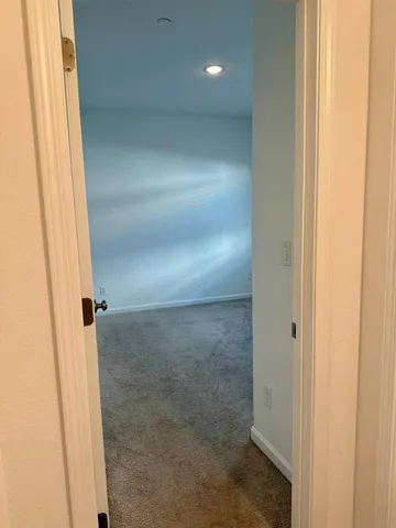 a view of a room with a ceiling fan and window