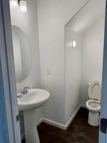 a bathroom with a sink toilet and a mirror