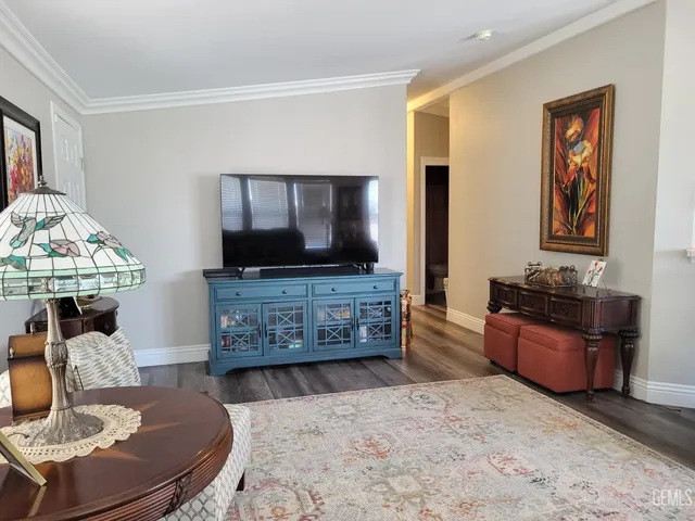 a living room with furniture and flat screen tv