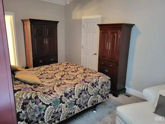 a bedroom with a bed and a dresser