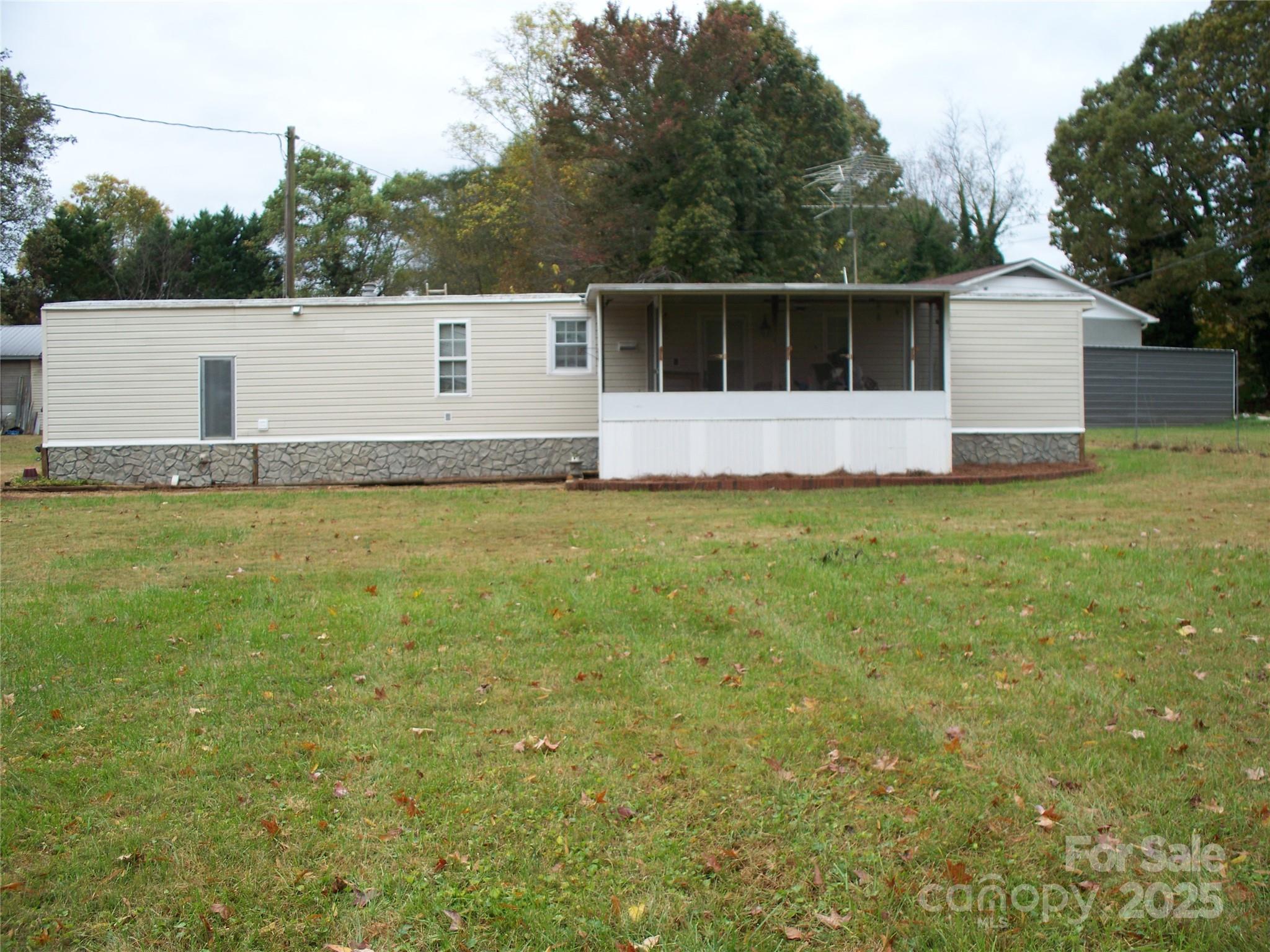 914 Salem Church Road Lincolnton, NC 28092 - Photo 4 of 22 a view of a white house and a yard with green space