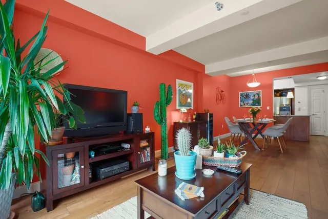 a living room with furniture a rug and a flat screen tv