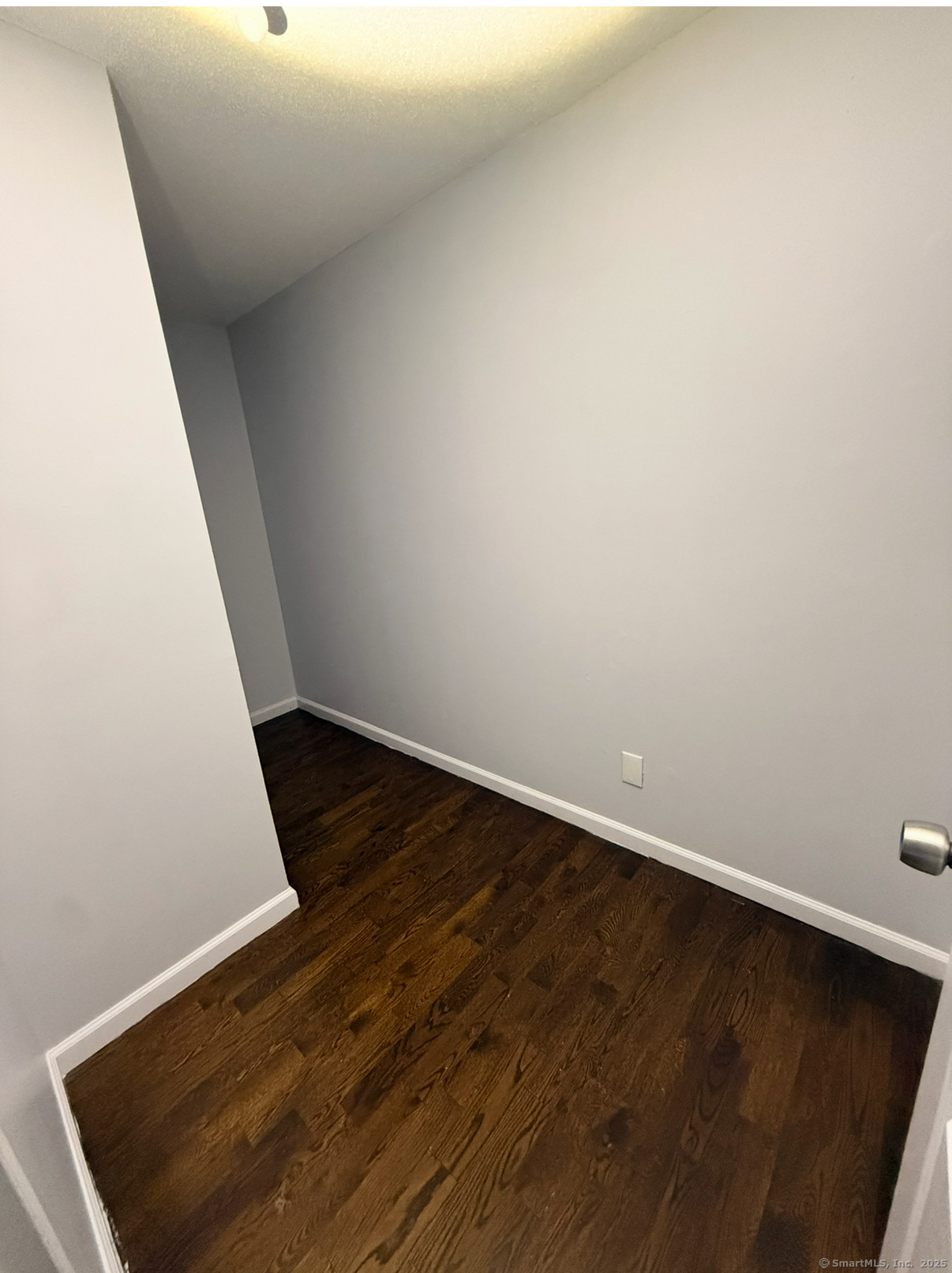 24 Coleman Street, Unit K West Haven, CT 06516 - Photo 4 of 6 an empty room with wooden floor