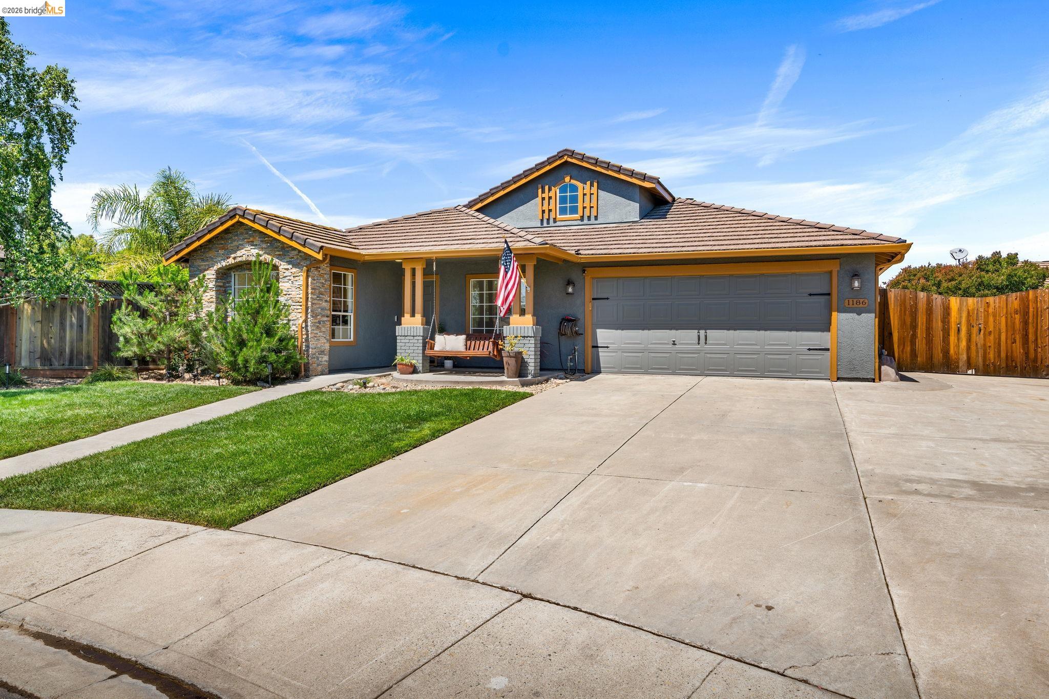 1186 El Rio Court Livermore, CA 94551 - Photo 6 of 60 Contemporary stucco exterior with a stone veneer accent, attached two-car garage, and a covered porch entry