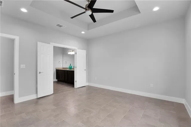 an empty room with a kitchen and a sink