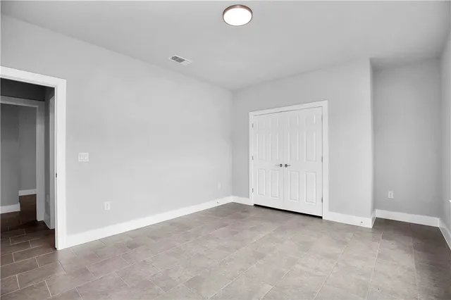 an empty room with closet area