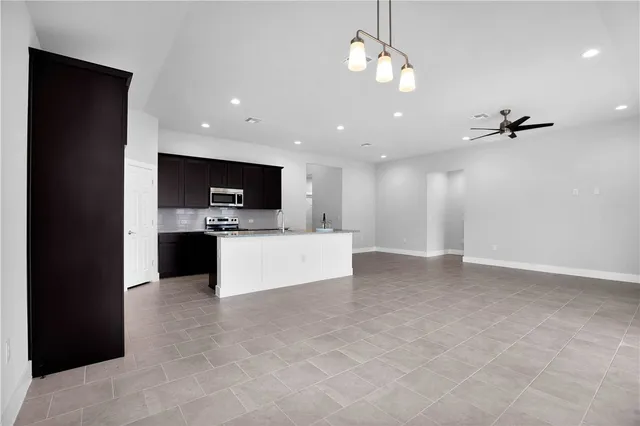 a view of kitchen with refrigerator and window