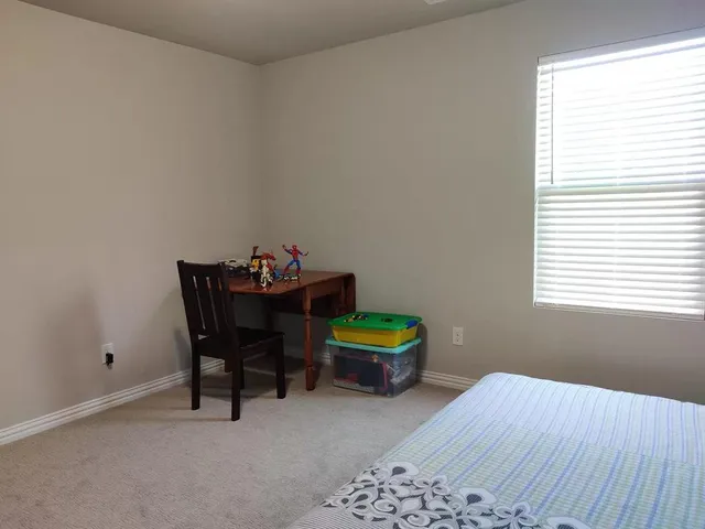 a room with a bed and a window