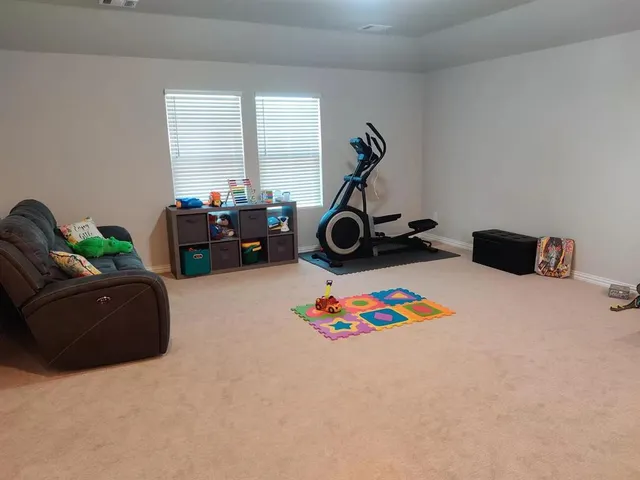 a bedroom with furniture and a wooden floor