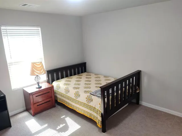 a bedroom with a bed and window