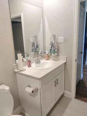 a bathroom with a glass shower door