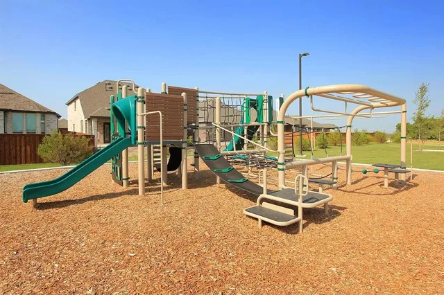 an aerial view of a house with a garden and lake view