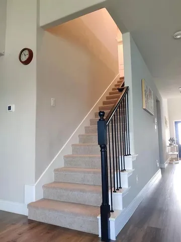 a view of entryway and hall with wooden floor