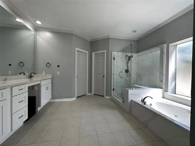 a bathroom with a double vanity sink a toilet and a bathtub