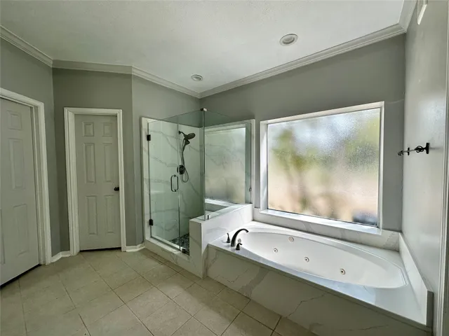 a bathroom with a tub shower and sink