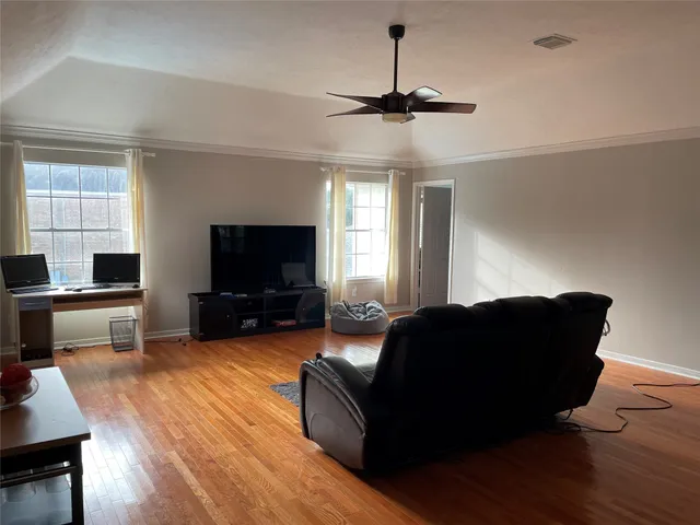 a living room with furniture and a flat screen tv