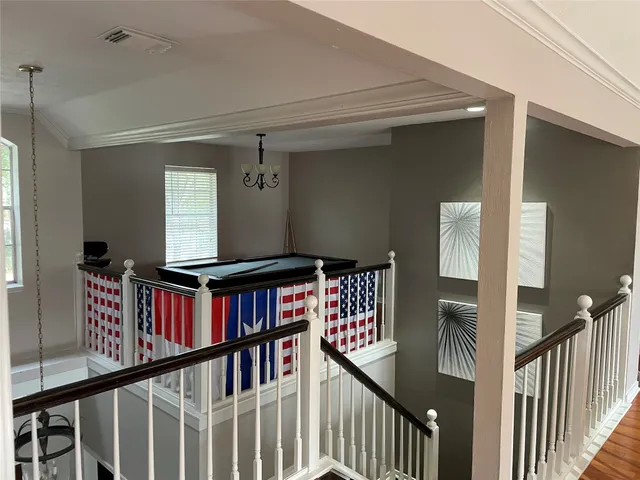a view of a hallway with windows and stairs