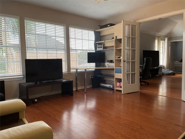 a living room with furniture and a flat screen tv