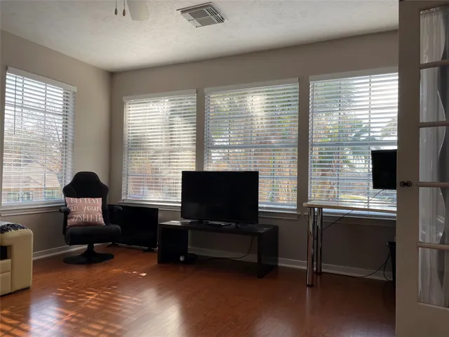 a view of a workspace with furniture and a window