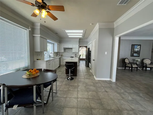 a view of a dining room with furniture and a chandelier