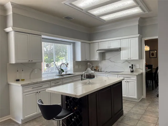 a kitchen with stainless steel appliances granite countertop a sink stove and cabinets